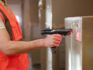 Warehouse worker scans QR code