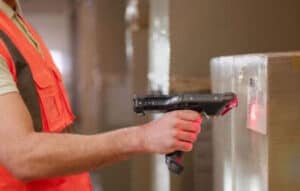 Warehouse worker scans QR code