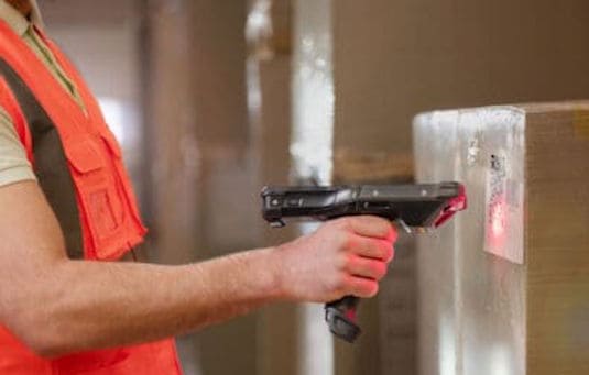 Warehouse worker scans QR code